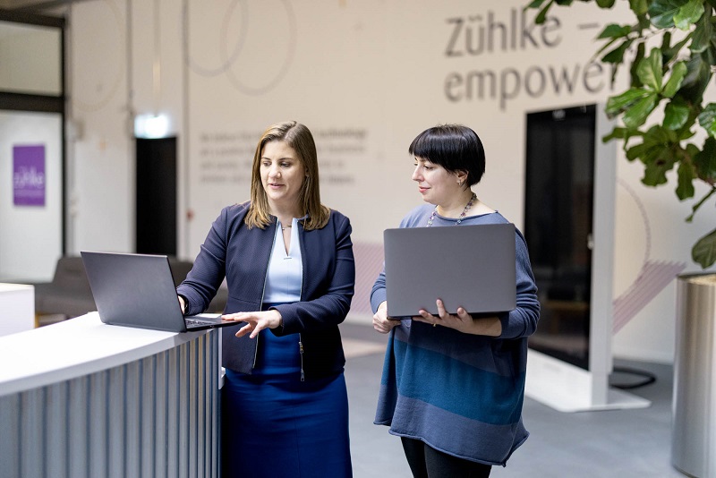 Two women standing in Zuehlke office around a laptop