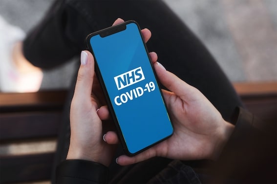 the NHS Covid-19 app on a mobile screen in the hands of a person