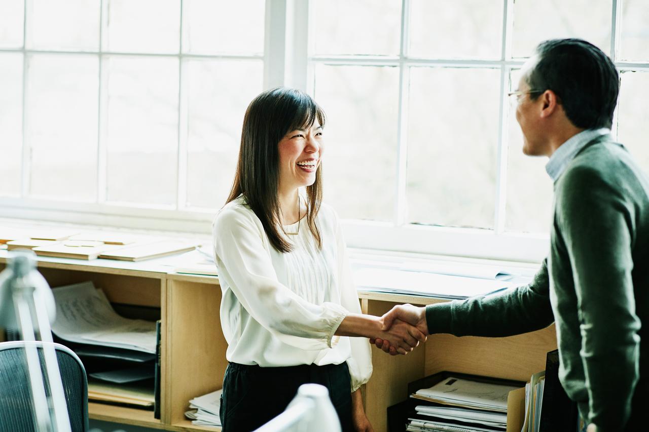 Businesswoman shaking hands with client