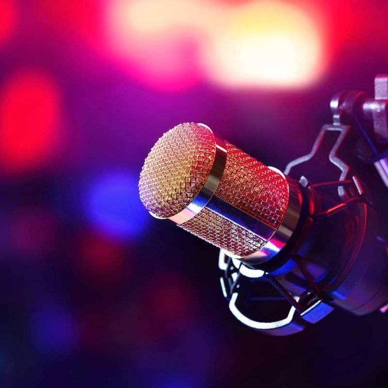 Professional microphone with blurry stage lights in the background